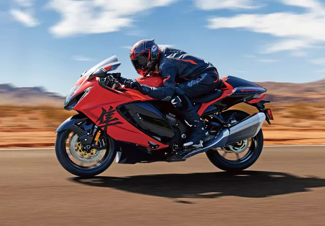 Suzuki Hayabusa 25th Anniversary powering down a road with a desert background