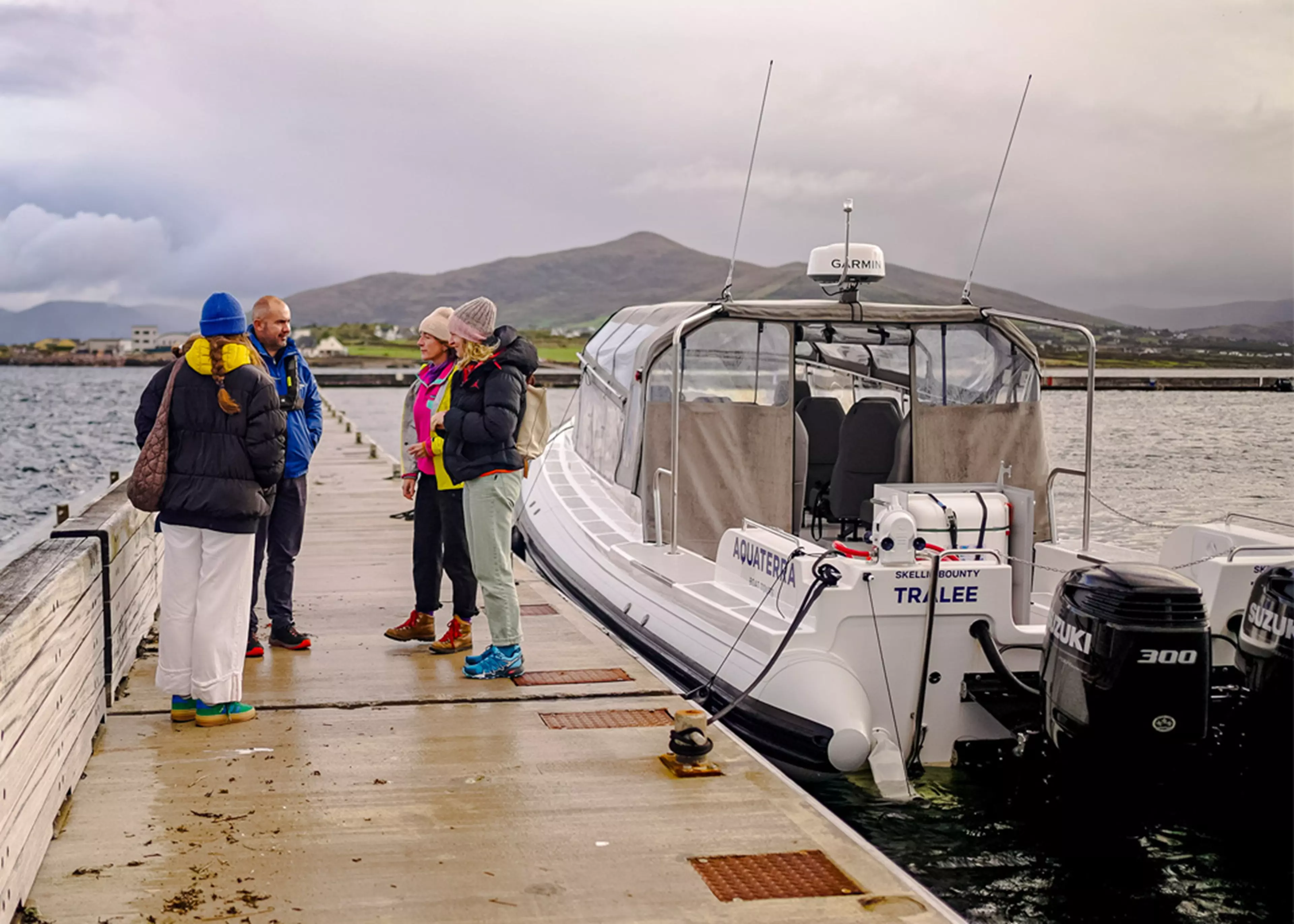 Skellig Bounty moored in a harbour, powered by twin Suzuki outboards