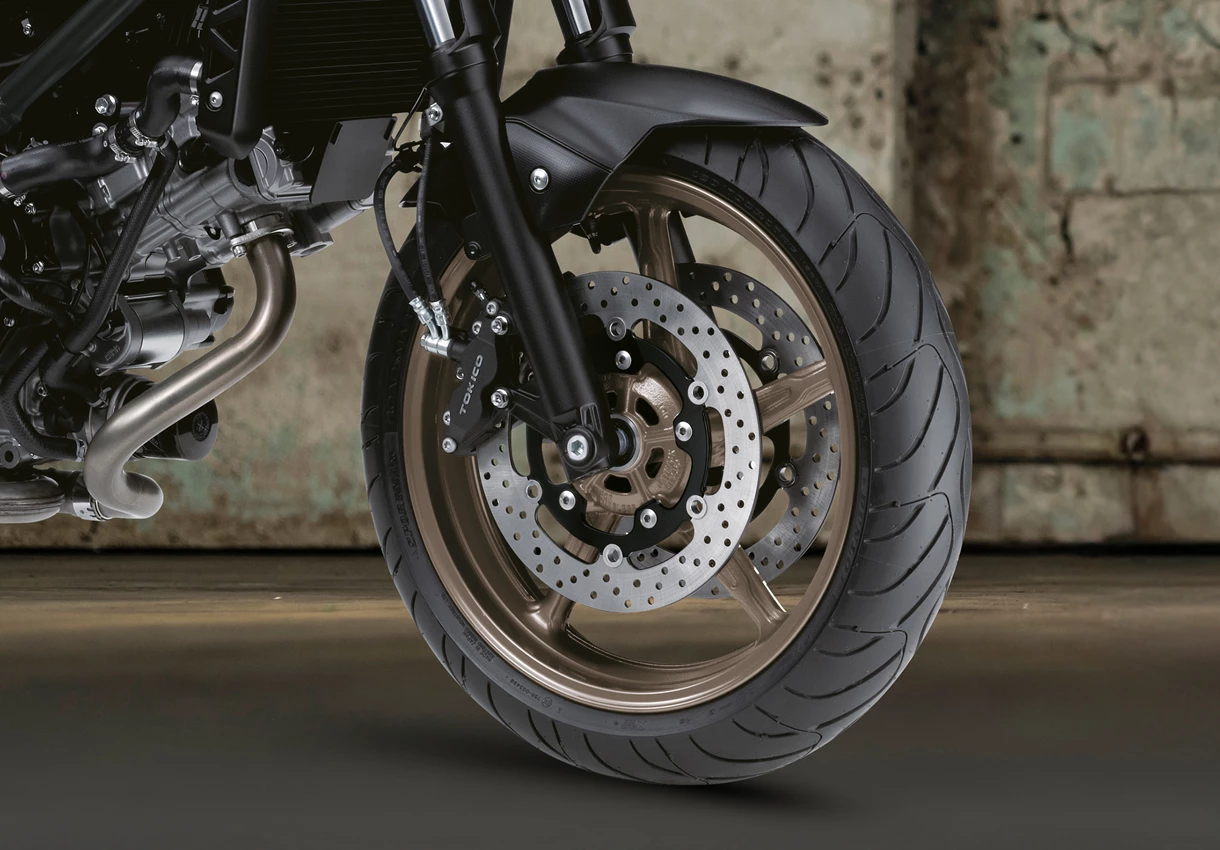 Suzuki SV650X front tyre close up with hanger door in the background