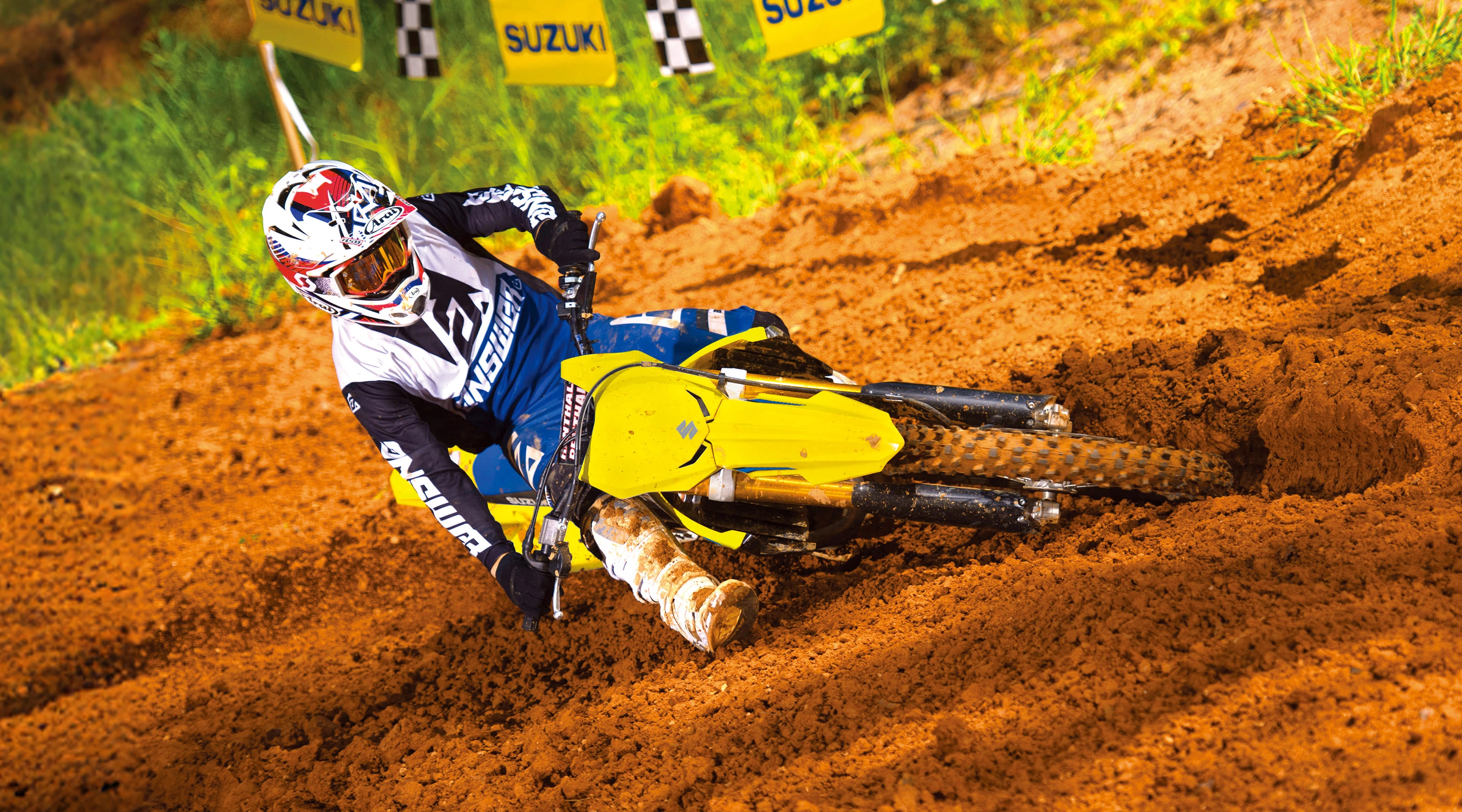 Suzuki RM-Z250 leaning heavily into a corner on a Motorcross track