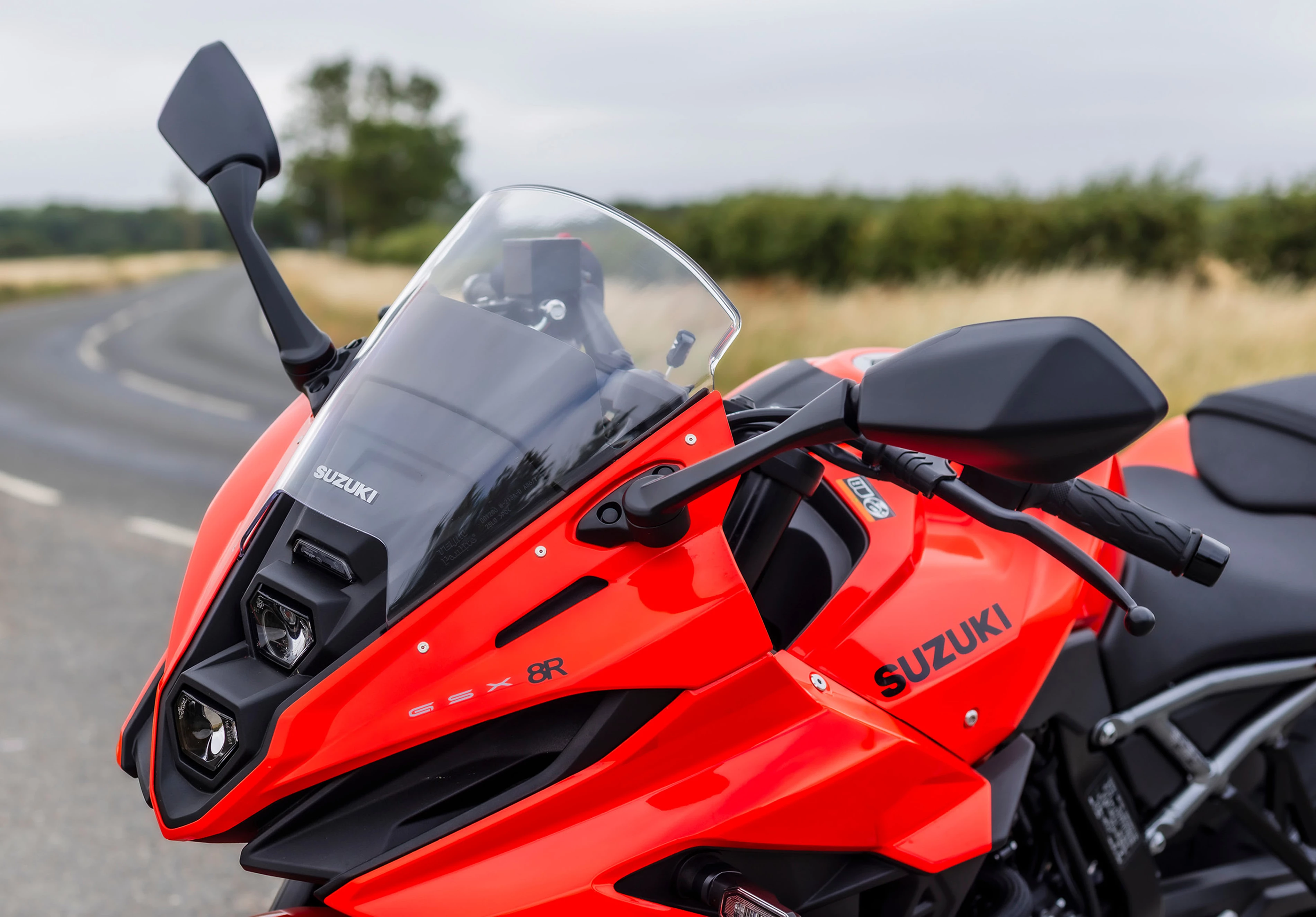 Suzuki GSX-8R front end close up from the right hand side with countryside in the background