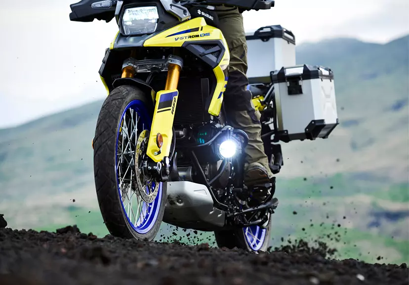 Suzuki V-Strom 1050DE Tour on a dirt trail with the rear wheel sliding