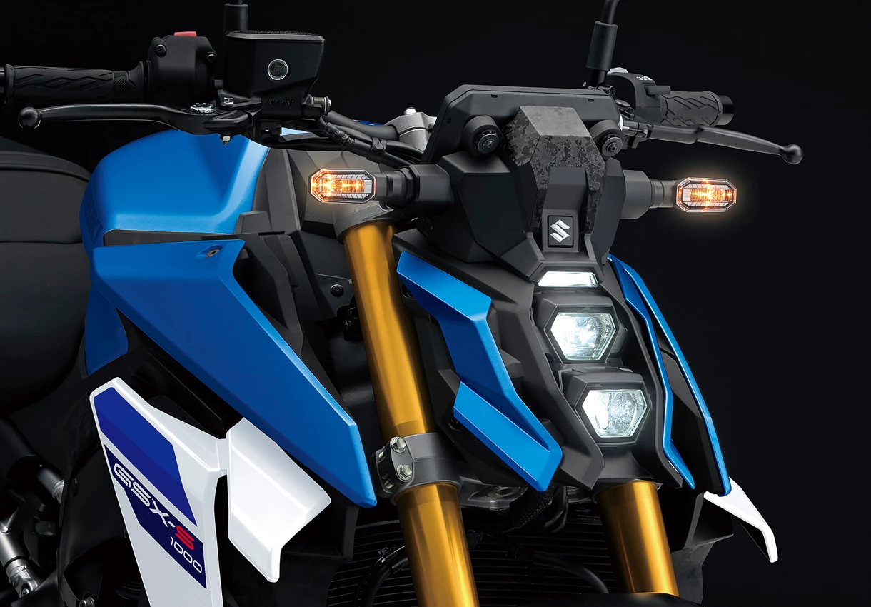 Suzuki GSX-S1000 front end with a focus on the lit LED headlights.