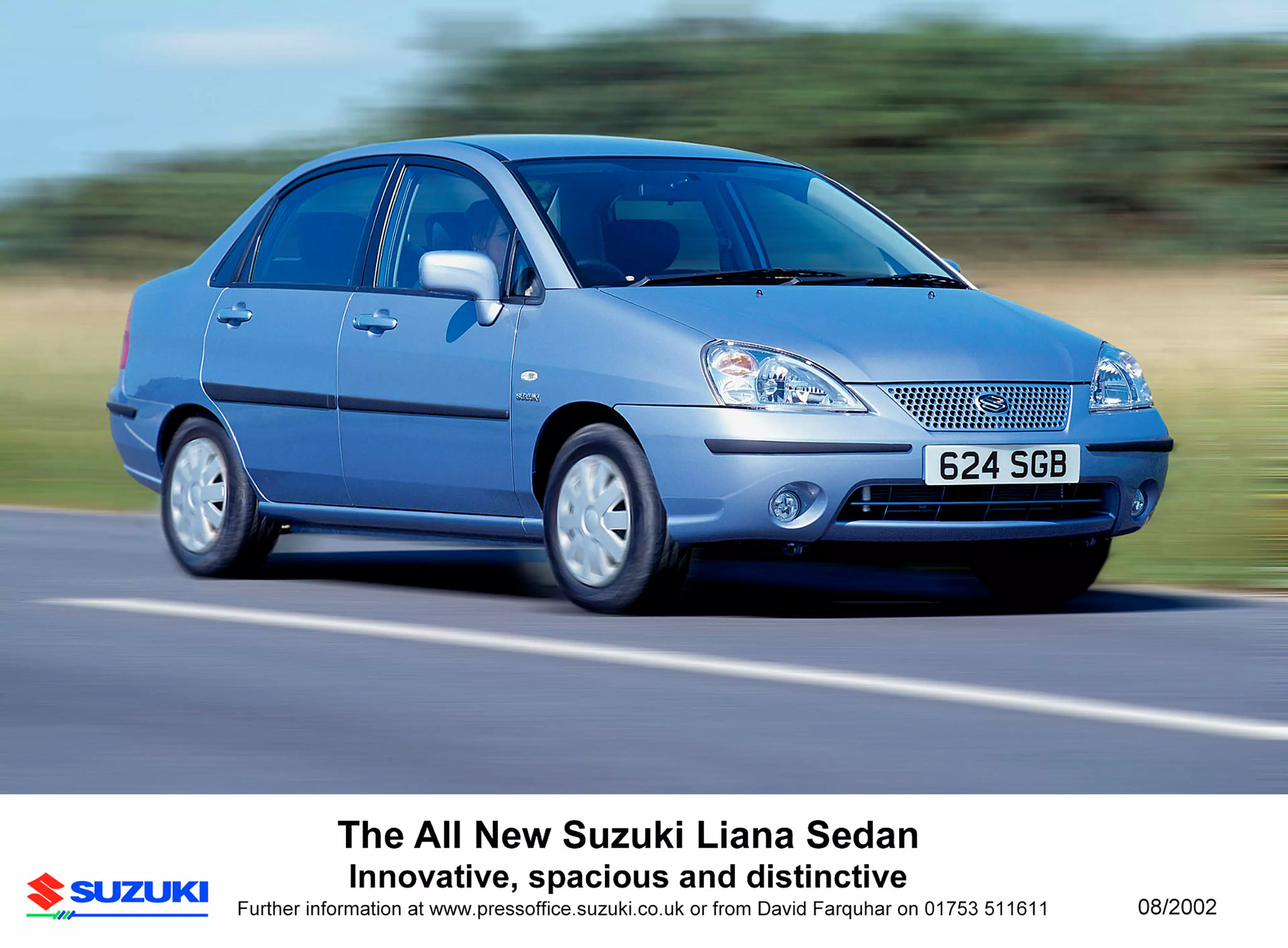 Blue Suzuki Liana Sedan driving on a road, shown in a promotional image with the text “The All New Suzuki Liana Sedan – Innovative, spacious and distinctive” and Suzuki branding