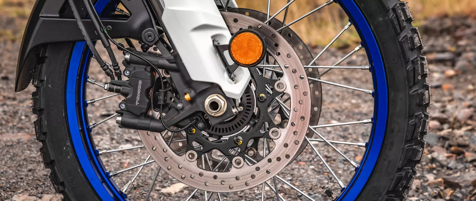 Suzuki V-Strom 1050DE white front wheel and forks right hand side close up