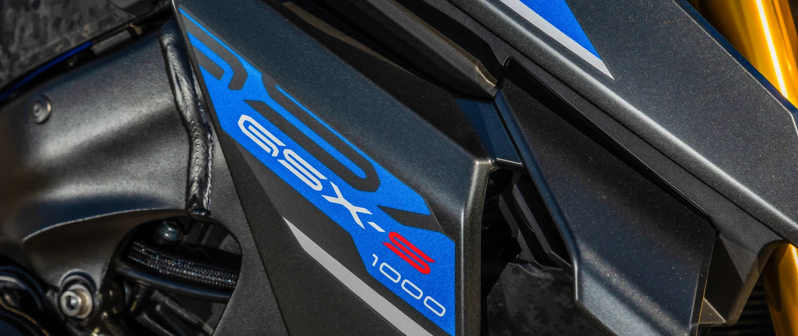 Suzuki GSX-S1000 blue side panel close up of GSX-S logo