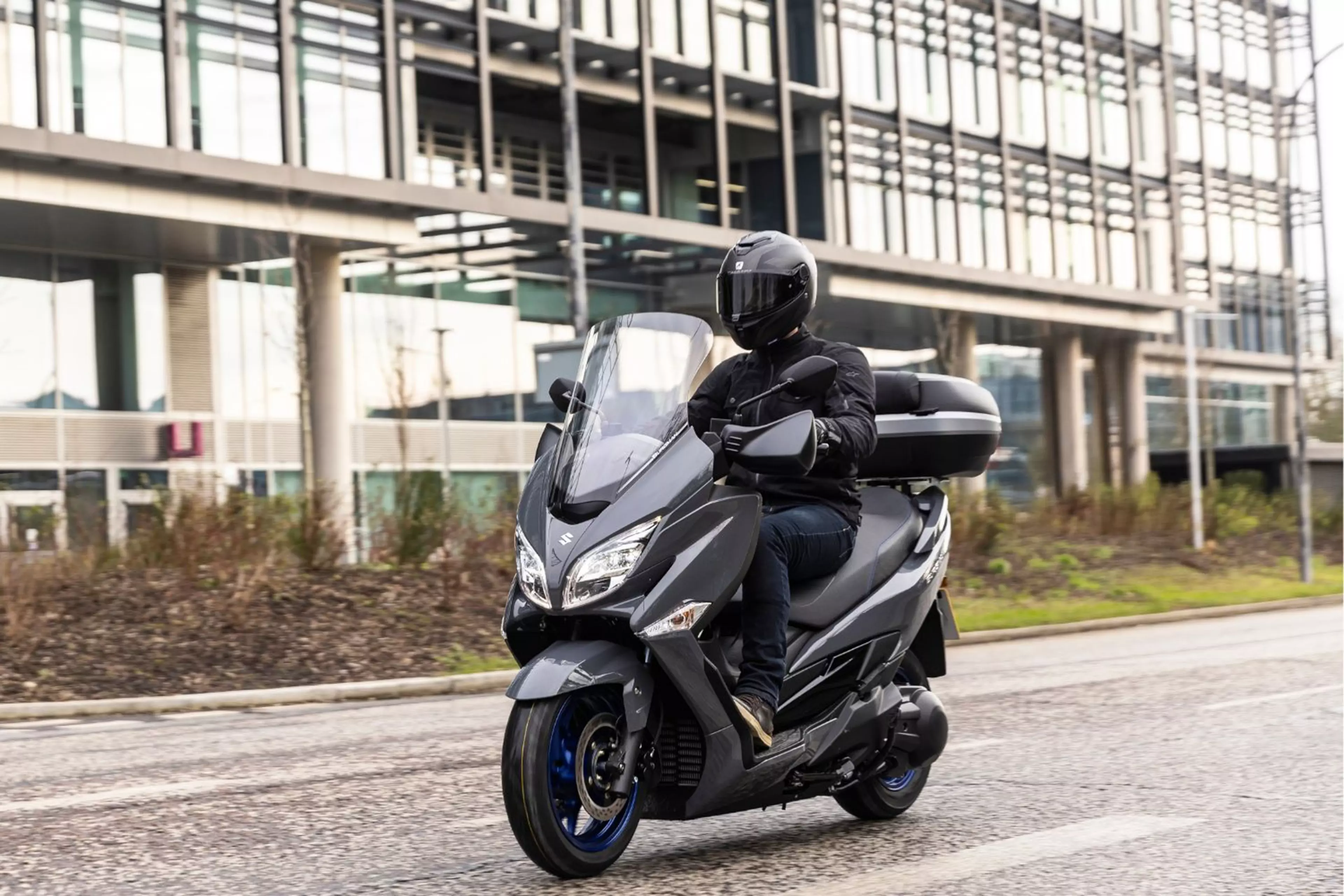 Suzuki Burgman 400 with commuter pack on city street