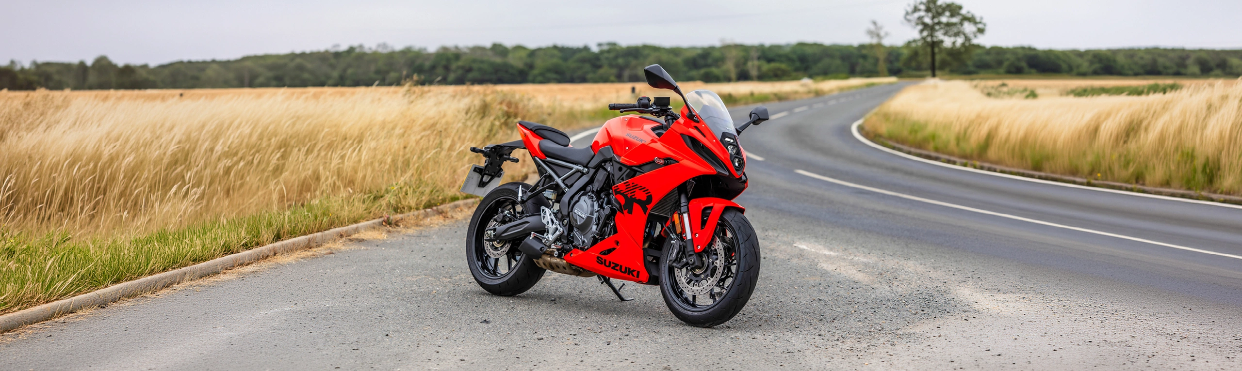 Suzuki GSX-8R orange on location static, right hand side with fields behind