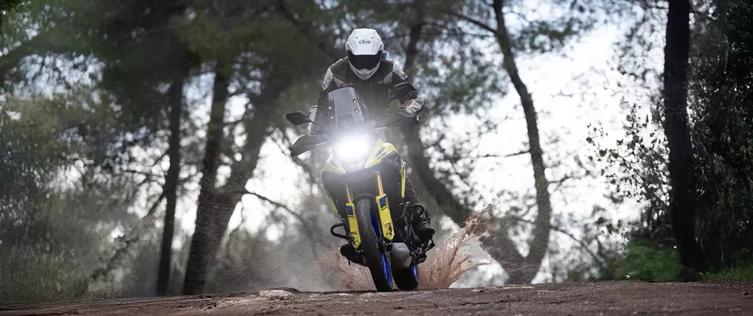Suzuki V-Strom 1050DE on a green lane pushing whilst coming over a hill