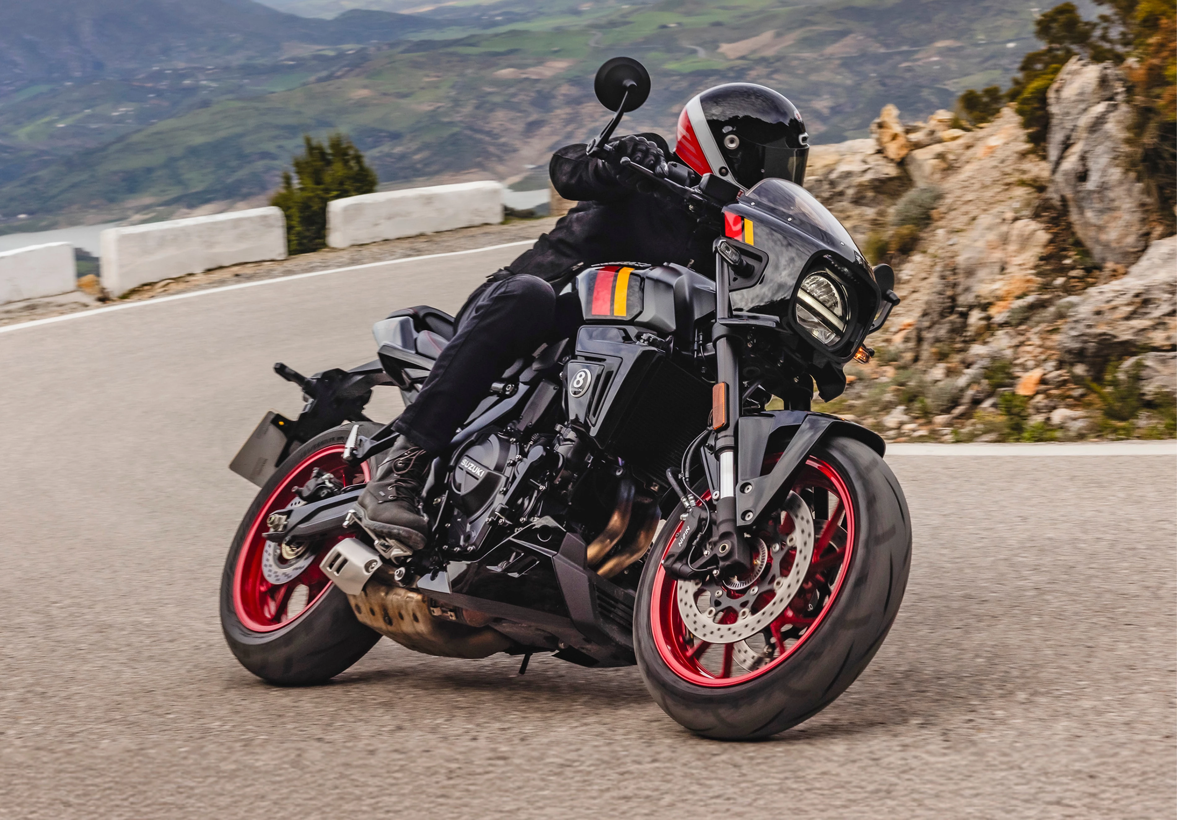 Suzuki GSX-8TT leaning hard into a corner on a mountain pass.