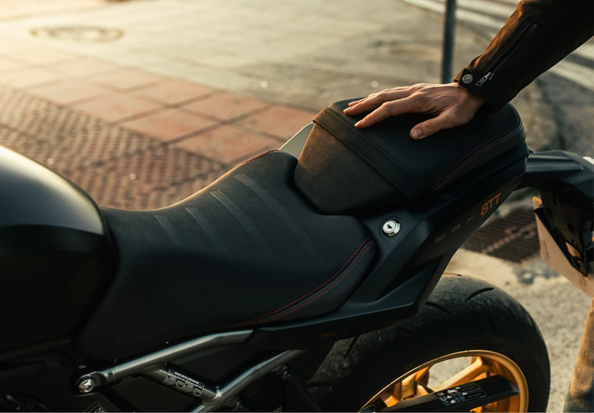 Suzuki GSX-8TT left hand side seat close up with riders hand on the pillion seat.
