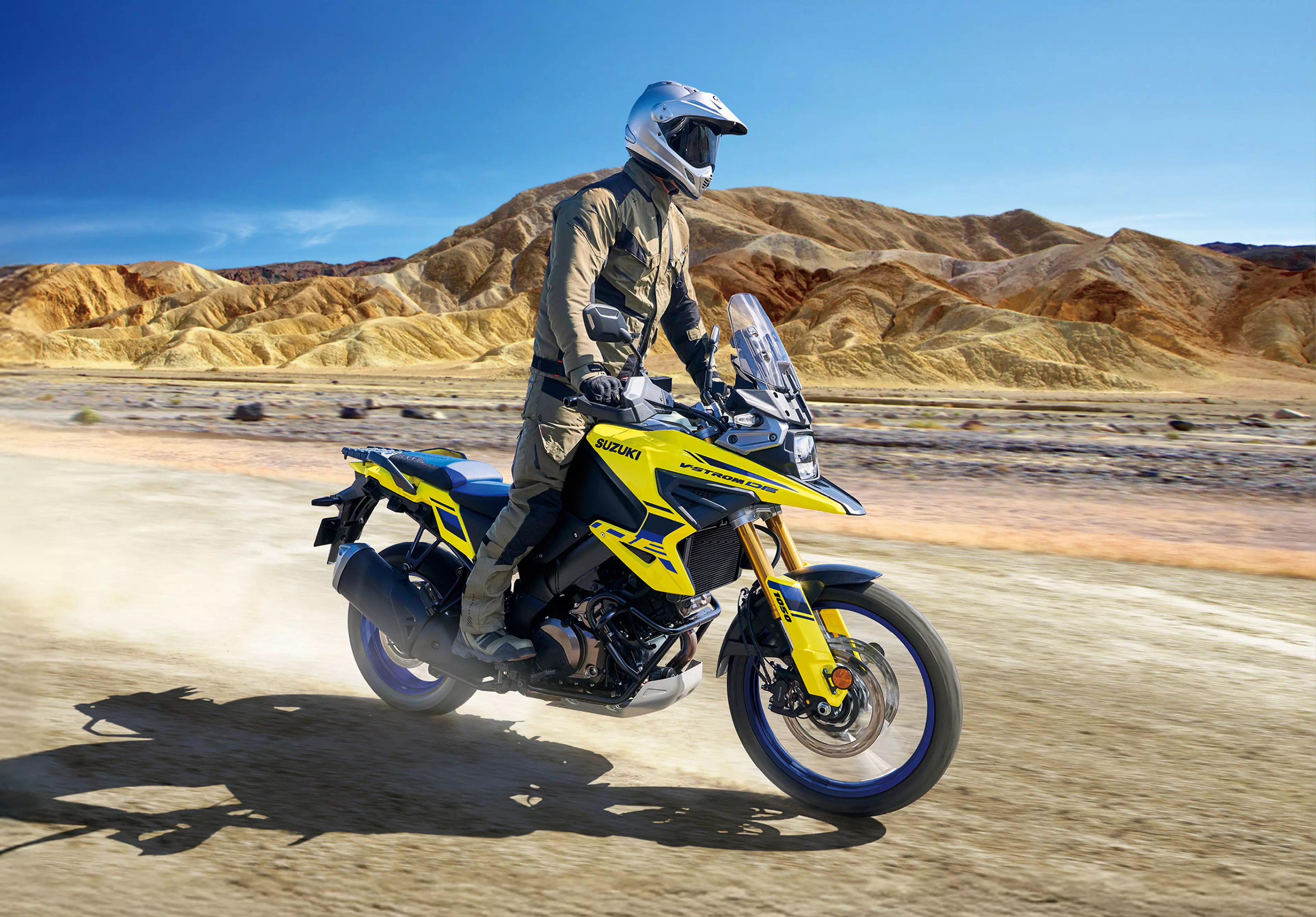 Suzuki V-Strom 1050DE Tour riding along a dirt desert track