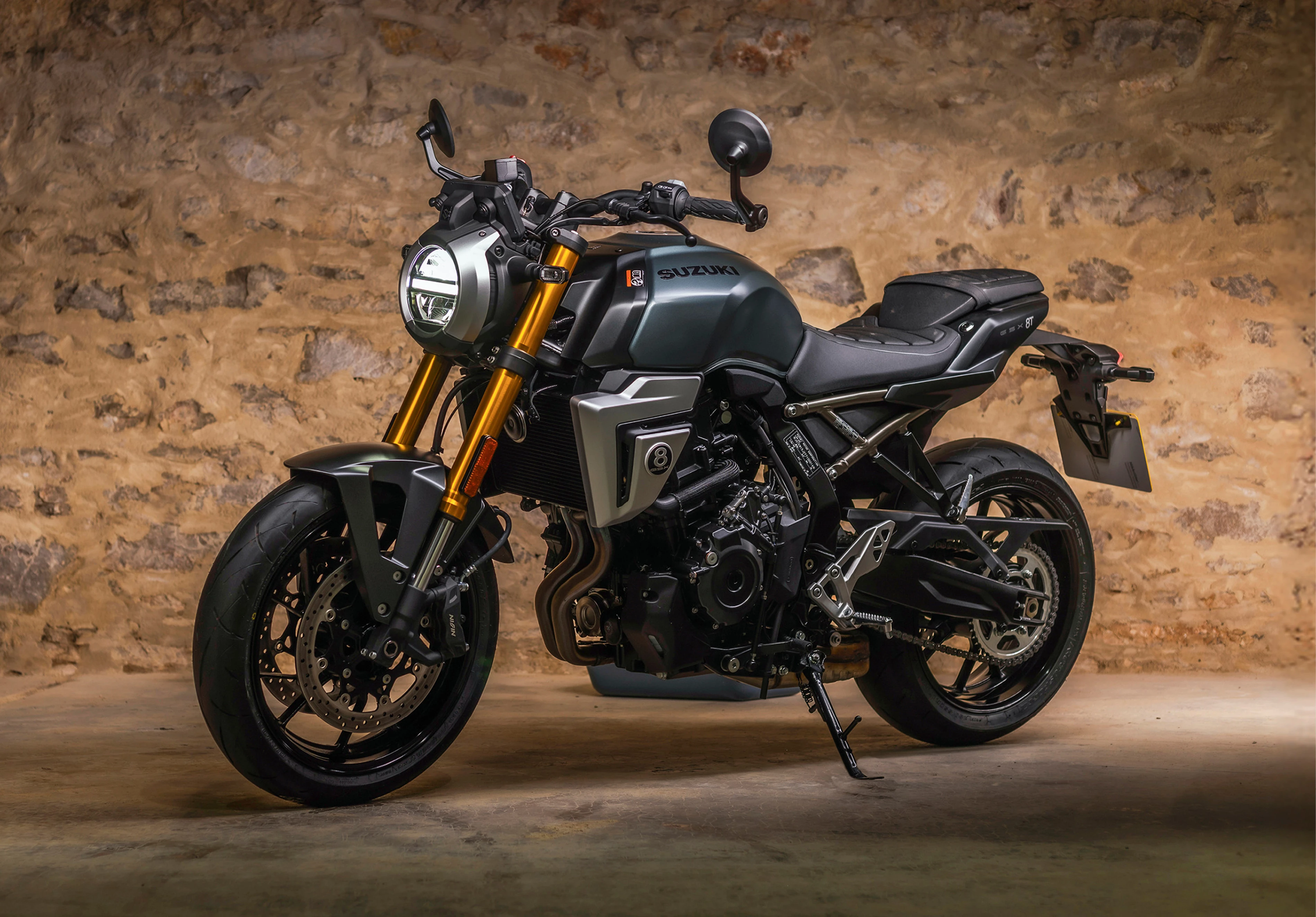 Suzuki GSX-8T left hand side static with a barn wall background