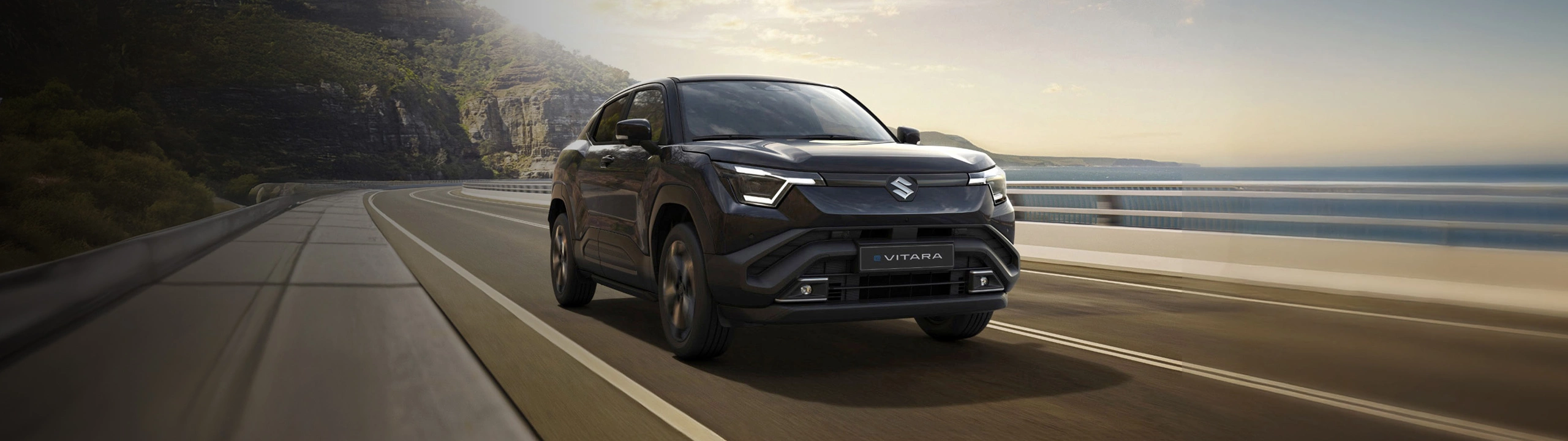 Suzuki e Vitara driving on the coast