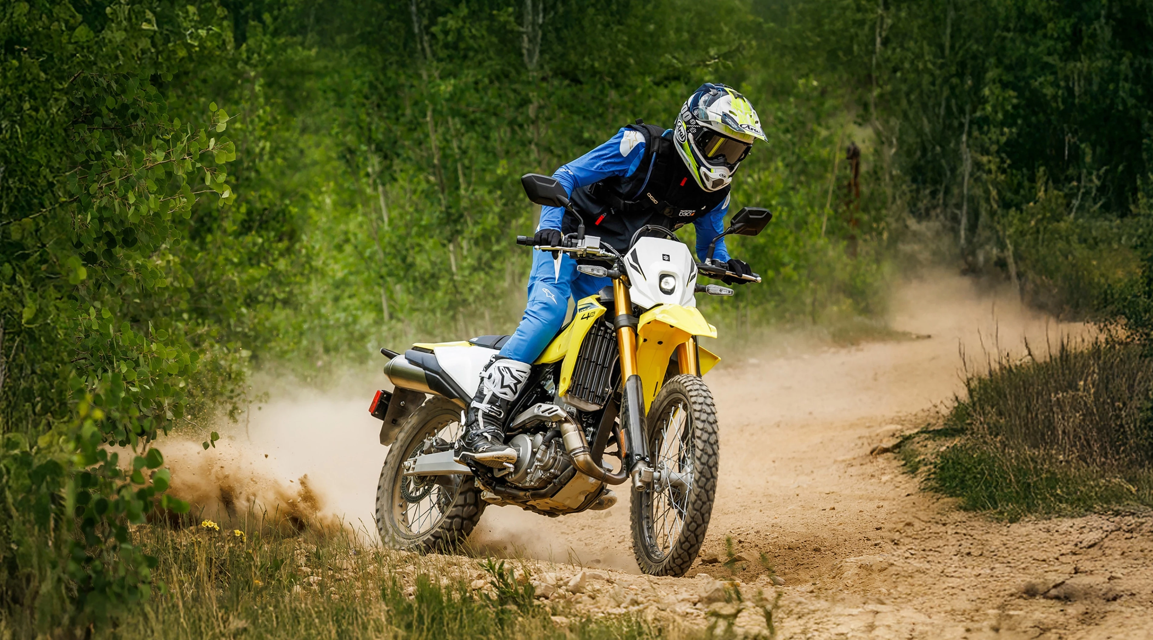 Suzuki DR-Z4S on a dirt track, accelerating around a corner.