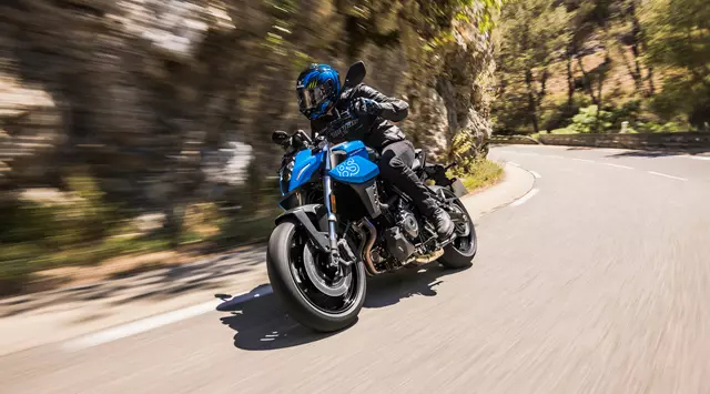 Suzuki GSX-8S leaning into a corner on a mountain road