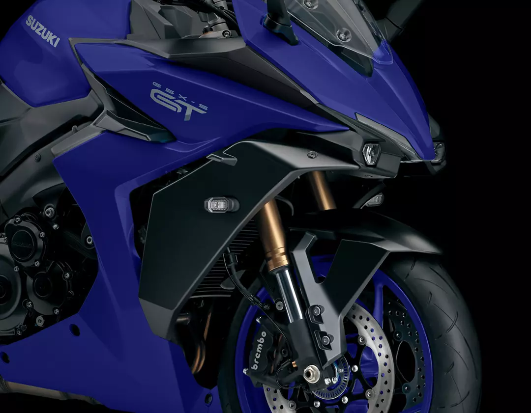 Close-up of the Suzuki GSX-S1000GT’s front wheel and brake assembly, highlighting the Brembo brake system for precision braking