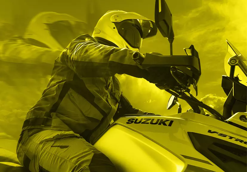 Suzuki V-Strom 1050DE low down shot looking up at the rider on the right hand side