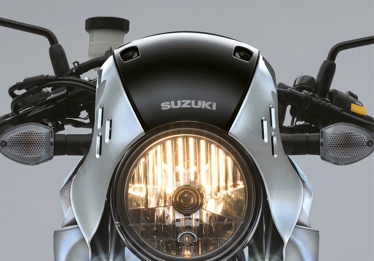 Suzuki SV650X headlight lit, close up 