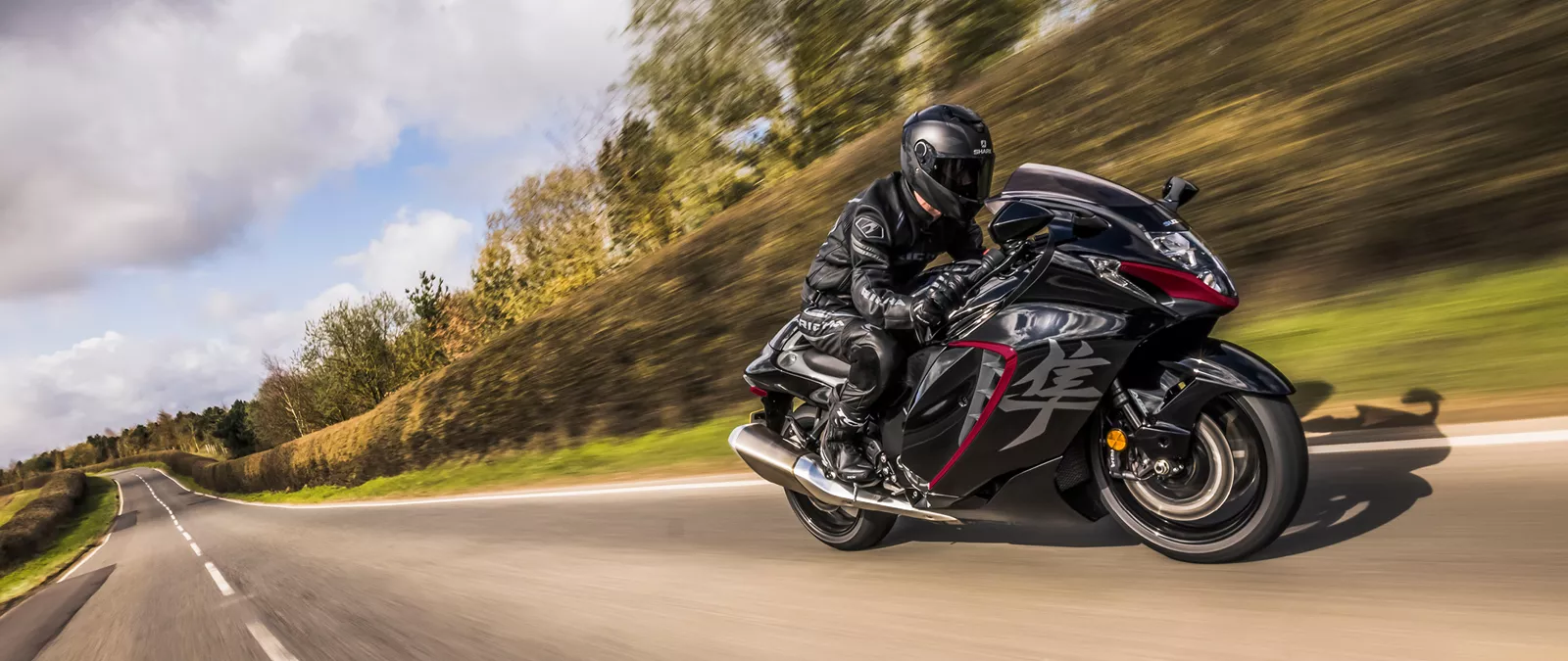 Suzuki Hayabusa black moving along a country ride