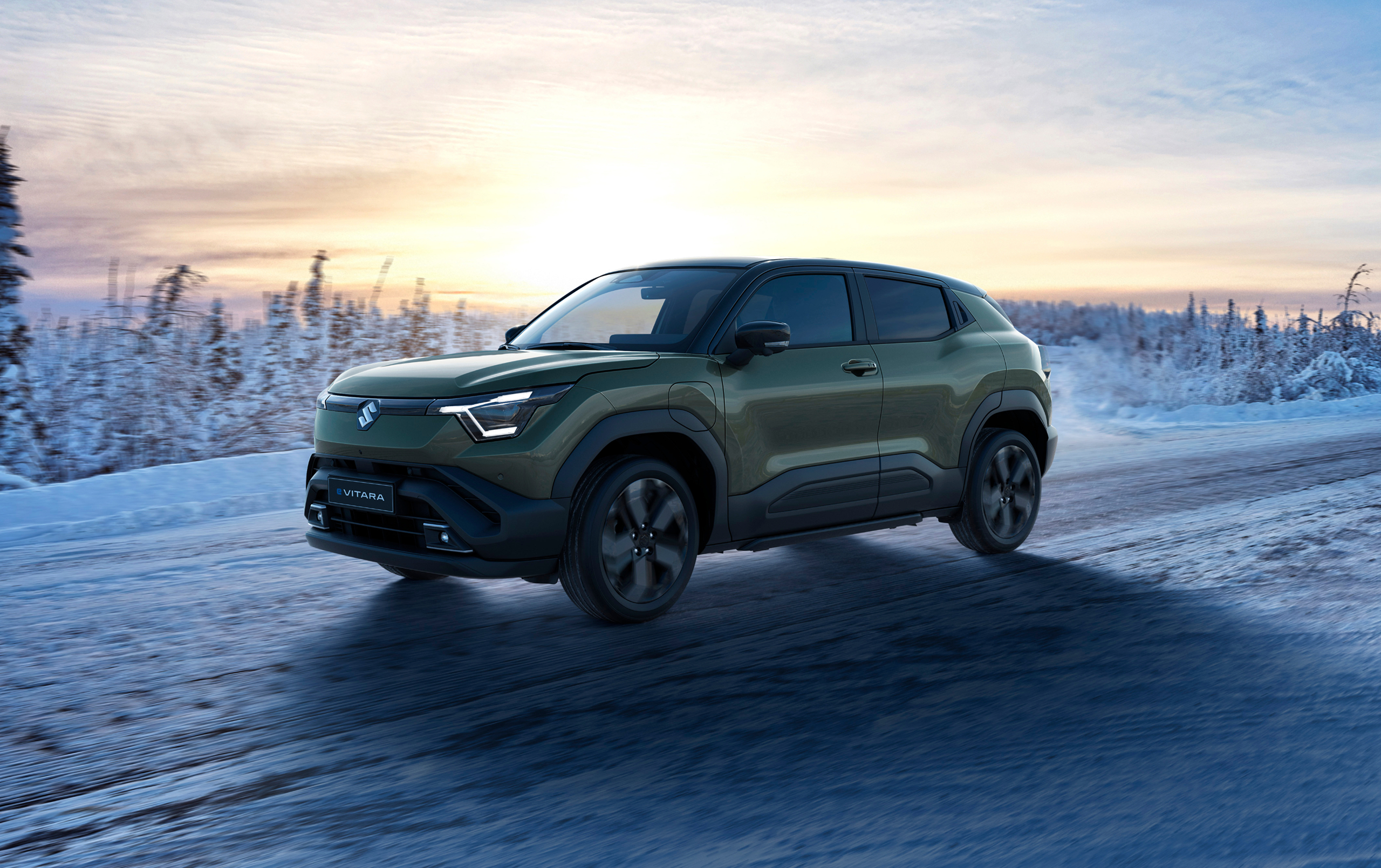 Suzuki e Vitara electric SUV driving on icy terrain, highlighting winter performance and electric capability.