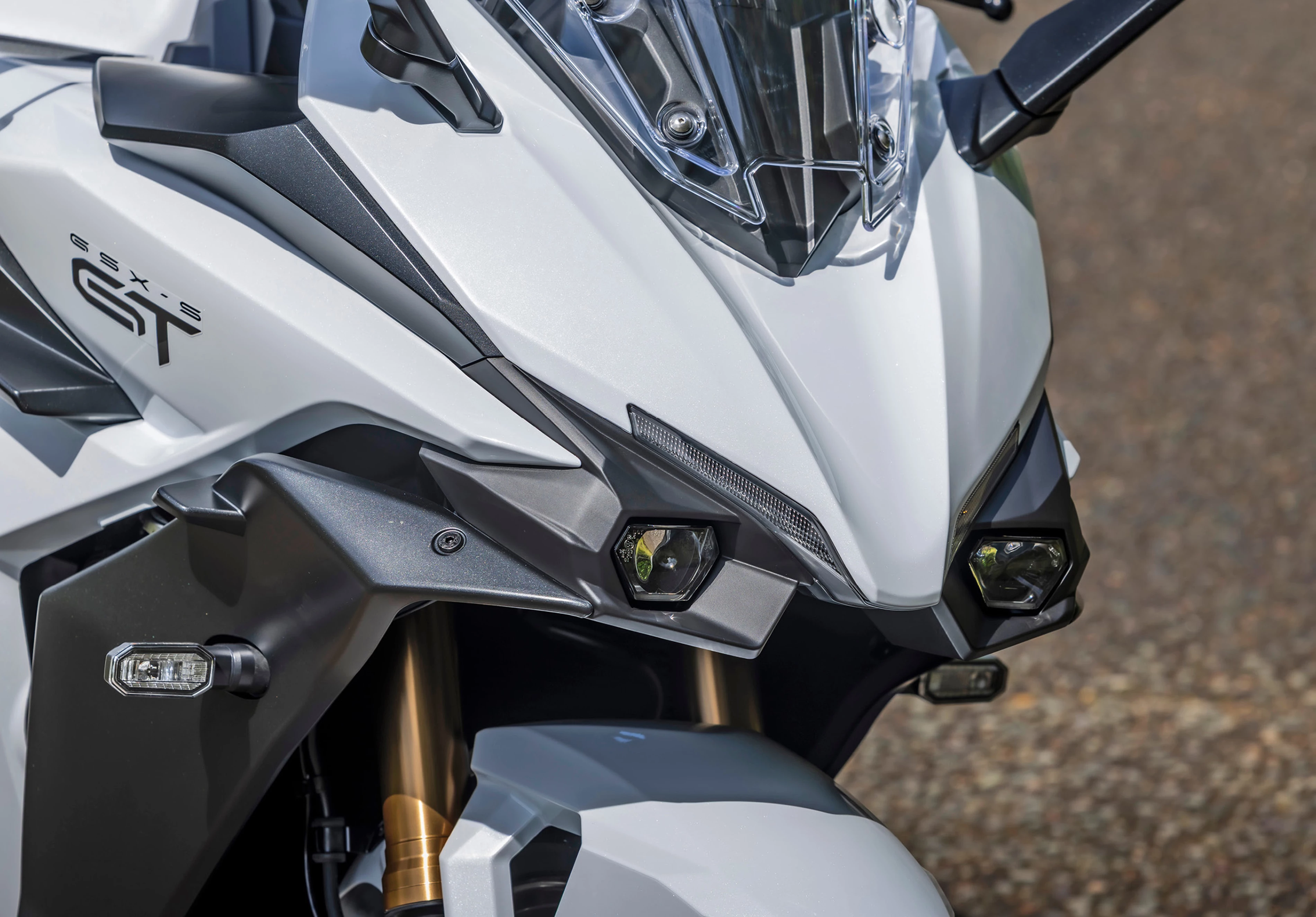 Suzuki GSX-S1000GT+ headlights front end close up.