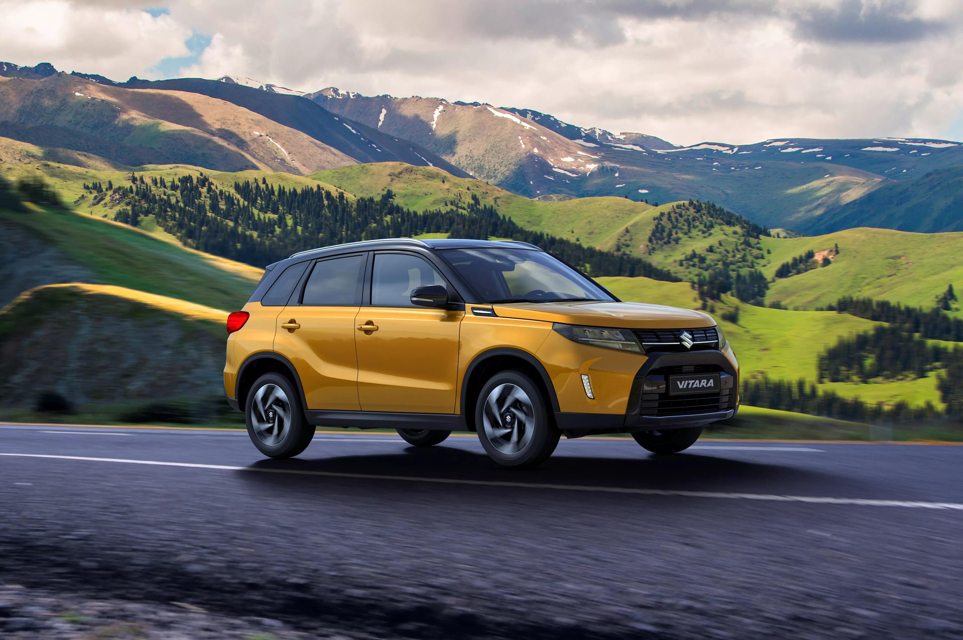 Suzuki Vitara yellow driving through mountains