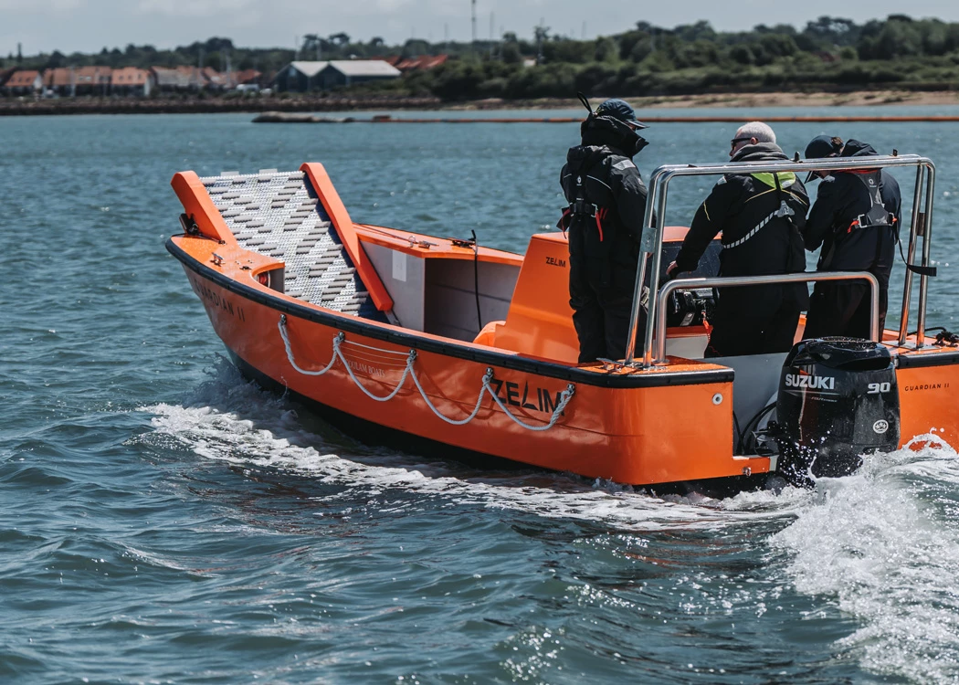 Orange boat from Coulam Marine with a Suzuki DF90A outboard