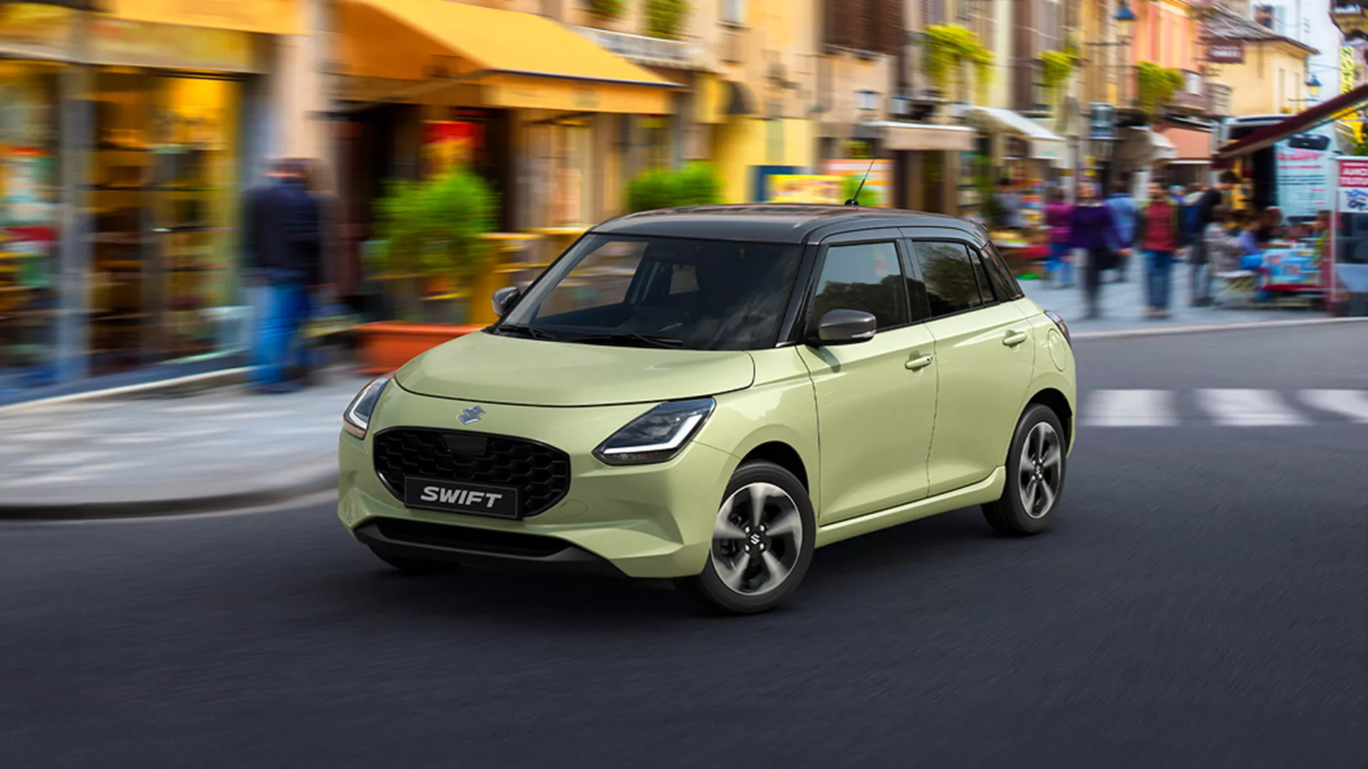 Cool Yellow Suzuki Swift driving through a city street