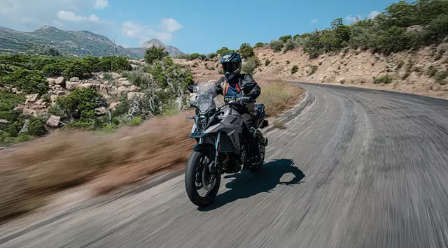 Suzuki V-Strom 800RE riding along a mountain road.
