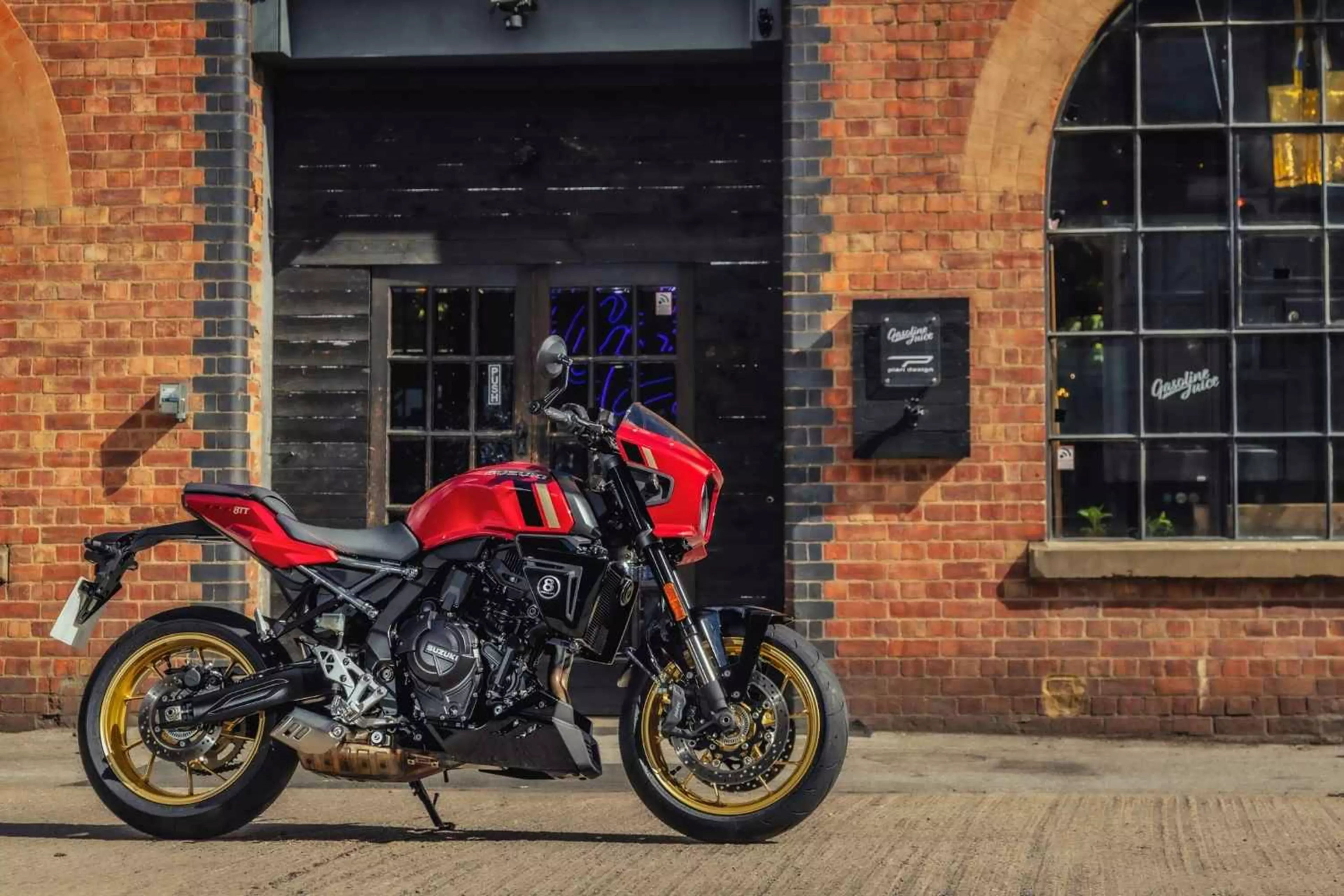 A red Suzuki 8TT outside Gasoline Juice