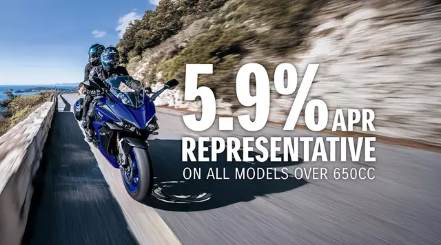 Suzuki GSX-S1000GT+ heading along a sea pass