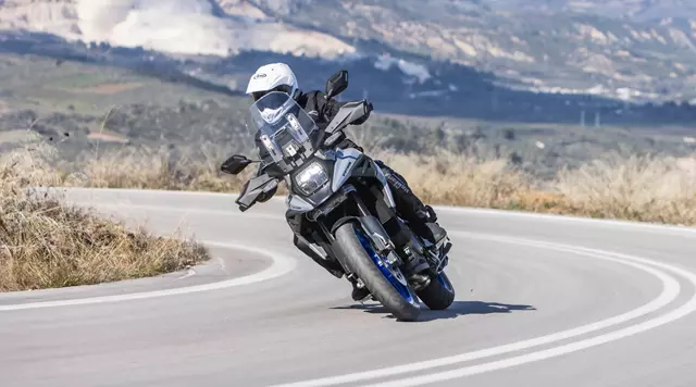 Suzuki V-Strom 1050 Tour leaning into a corner on a mountain pass