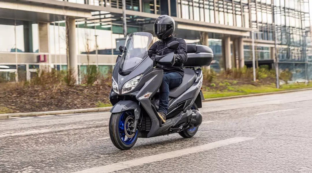 Suzuki Burgman 400 with commuter pack on city street