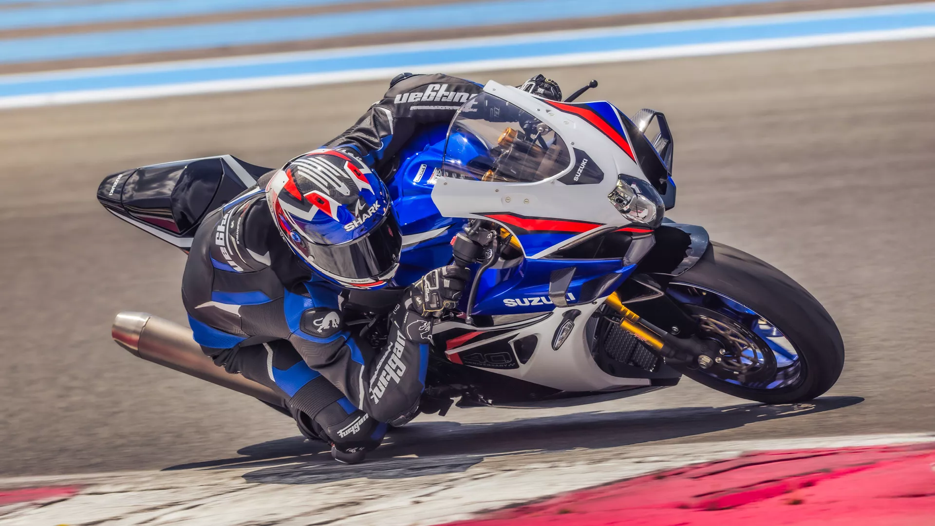 Suzuki GSX-R1000R blue, at full lean angle out on track
