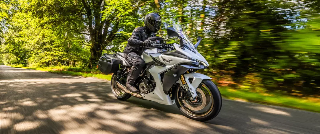 Suzuki GSX-S1000GT+ on a tree lined road