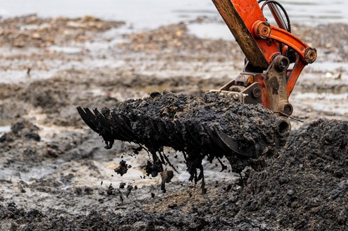 A close up of the digger bucket removing material at Wet Wipe Island in London