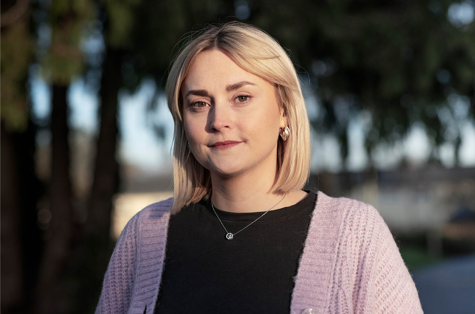 Portrait of woman outdoors near trees